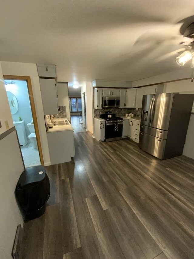 14441 Dante Ave, Dolton, IL 60419 - kitchen featuring appliances with stainless steel finishes, a ceiling fan, light countertops, decorative backsplash, and dark wood finished floors