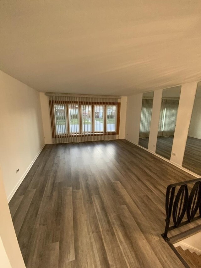 14441 Dante Ave, Dolton, IL 60419 - unfurnished living room featuring dark wood finished floors and baseboards
