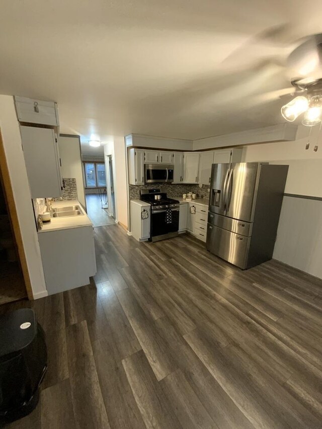 14441 Dante Ave, Dolton, IL 60419 - kitchen with appliances with stainless steel finishes, a ceiling fan, light countertops, dark wood-style floors, and tasteful backsplash