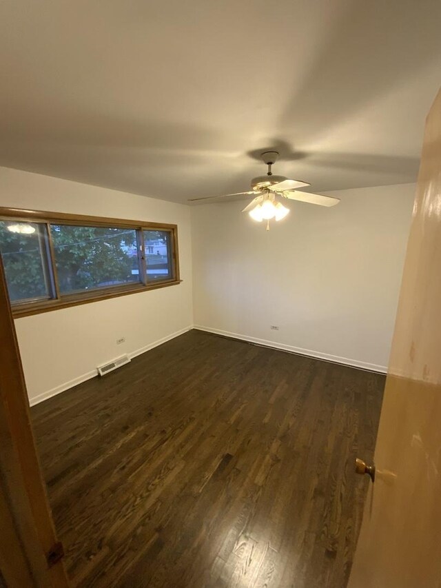 14441 Dante Ave, Dolton, IL 60419 - unfurnished room with dark wood-style floors and a ceiling fan