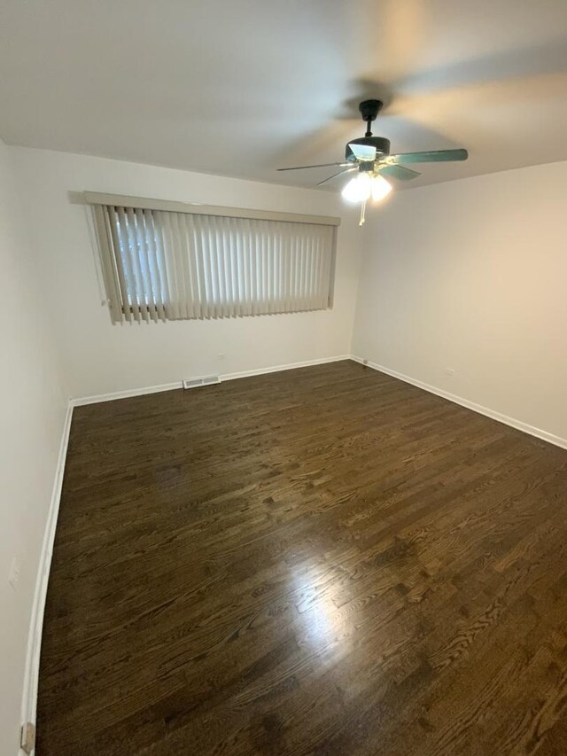 14441 Dante Ave, Dolton, IL 60419 - empty room featuring ceiling fan and dark wood-style flooring