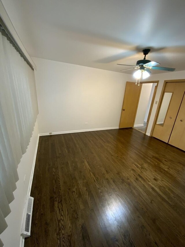 14441 Dante Ave, Dolton, IL 60419 - unfurnished living room with ceiling fan, wood finished floors, and stairway