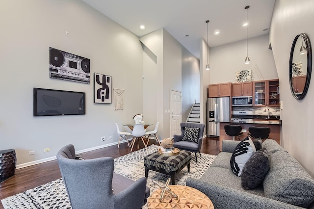 1622 W Ontario St Unit 1E, Chicago, IL 60622 - living area with stairway, dark wood-type flooring, a towering ceiling, and recessed lighting