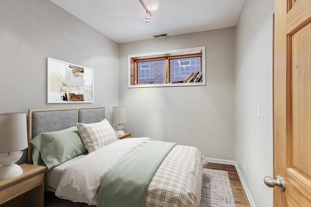 1622 W Ontario St Unit 1E, Chicago, IL 60622 - bedroom featuring wood finished floors and rail lighting