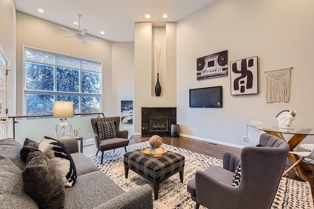 1622 W Ontario St Unit 1E, Chicago, IL 60622 - living room with wood finished floors, ceiling fan, recessed lighting, a tile fireplace, and a towering ceiling