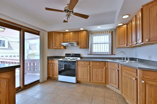 5010 N Merrimac Ave, Chicago, IL 60630 - kitchen featuring gas range oven, under cabinet range hood, dark countertops, and recessed lighting