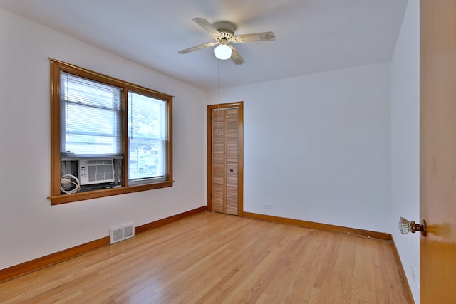 5010 N Merrimac Ave, Chicago, IL 60630 - unfurnished room featuring light wood-style floors, a ceiling fan, and cooling unit