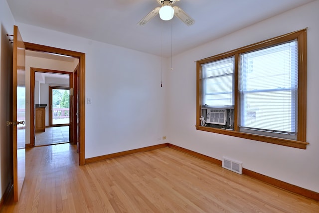 5010 N Merrimac Ave, Chicago, IL 60630 - spare room with light wood-style flooring, ceiling fan, and cooling unit
