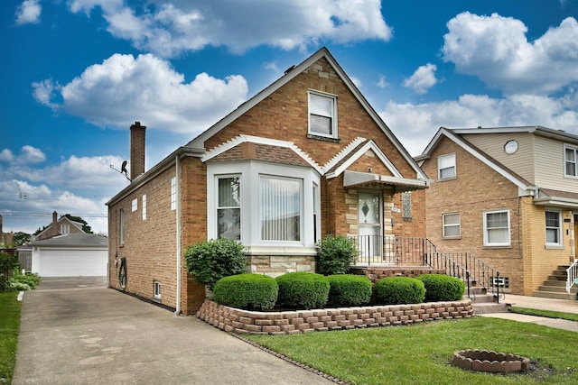 5010 N Merrimac Ave, Chicago, IL 60630 - view of front of home featuring an outbuilding, brick siding, a garage, a chimney, and a front yard