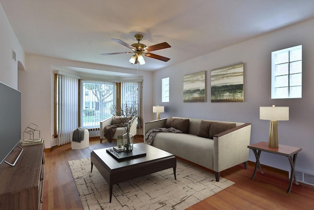5010 N Merrimac Ave, Chicago, IL 60630 - living room featuring ceiling fan, radiator heating unit, and light wood-type flooring