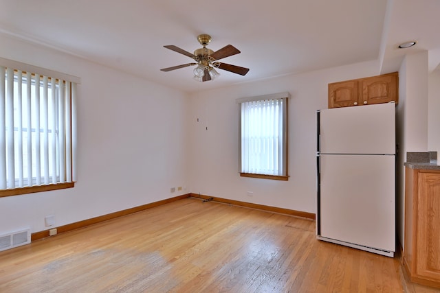 5010 N Merrimac Ave, Chicago, IL 60630 - kitchen with freestanding refrigerator, light wood finished floors, a ceiling fan, and dark countertops