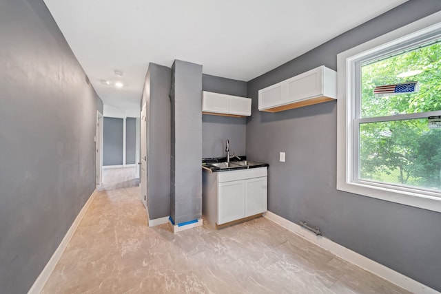 13834 Turner Ave, Robbins, IL 60472 - kitchen with white cabinets and baseboards