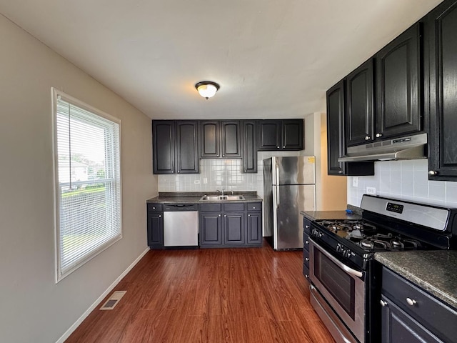 20552 S Frankfort Square Rd, Frankfort, IL 60423 - kitchen with appliances with stainless steel finishes, under cabinet range hood, dark wood-type flooring, tasteful backsplash, and dark countertops