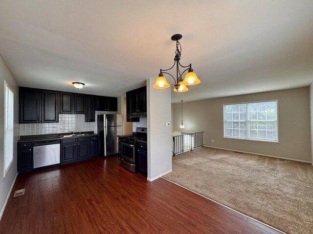 20552 S Frankfort Square Rd, Frankfort, IL 60423 - kitchen with stainless steel appliances, dark wood-style floors, dark countertops, dark cabinetry, and a chandelier