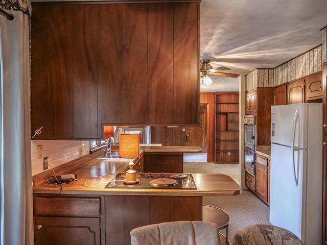 110 Hickory, Villa Grove, IL 61956 - kitchen featuring freestanding refrigerator, carpet, electric stovetop, a ceiling fan, and a kitchen breakfast bar
