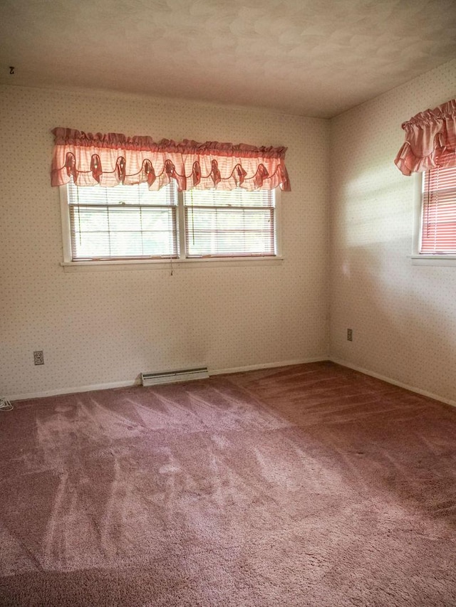 110 Hickory, Villa Grove, IL 61956 - empty room featuring a baseboard heating unit, carpet flooring, and wallpapered walls