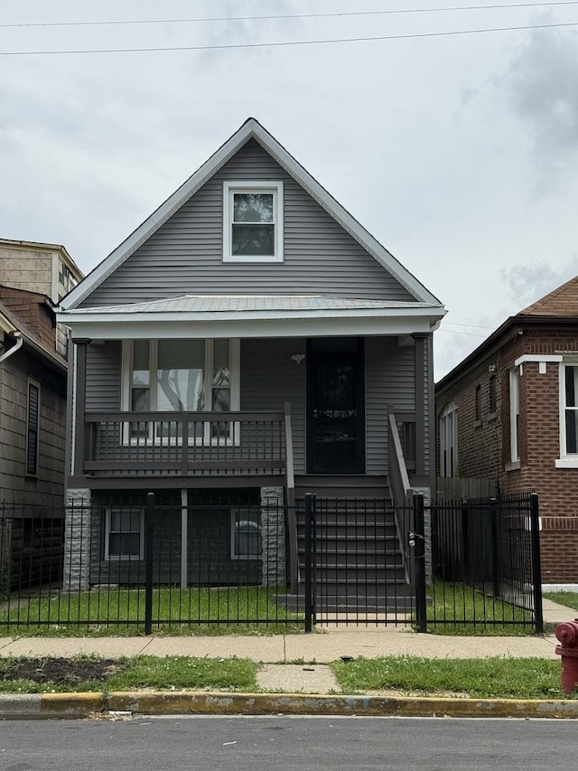7130 S Morgan St, Chicago, IL 60621 - view of front facade featuring covered porch, a fenced front yard, and a gate