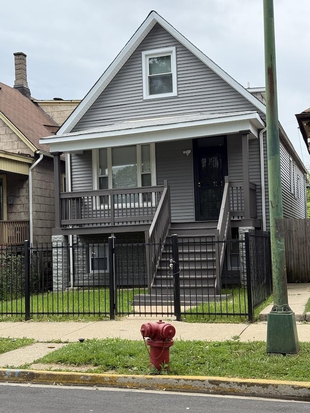 7130 S Morgan St, Chicago, IL 60621 - view of front of property featuring a porch, a fenced front yard, and stairway