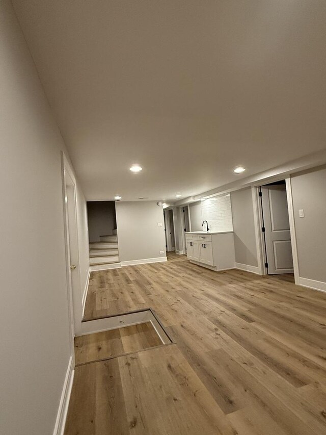 7130 S Morgan St, Chicago, IL 60621 - finished below grade area with light wood-style floors, recessed lighting, and stairs