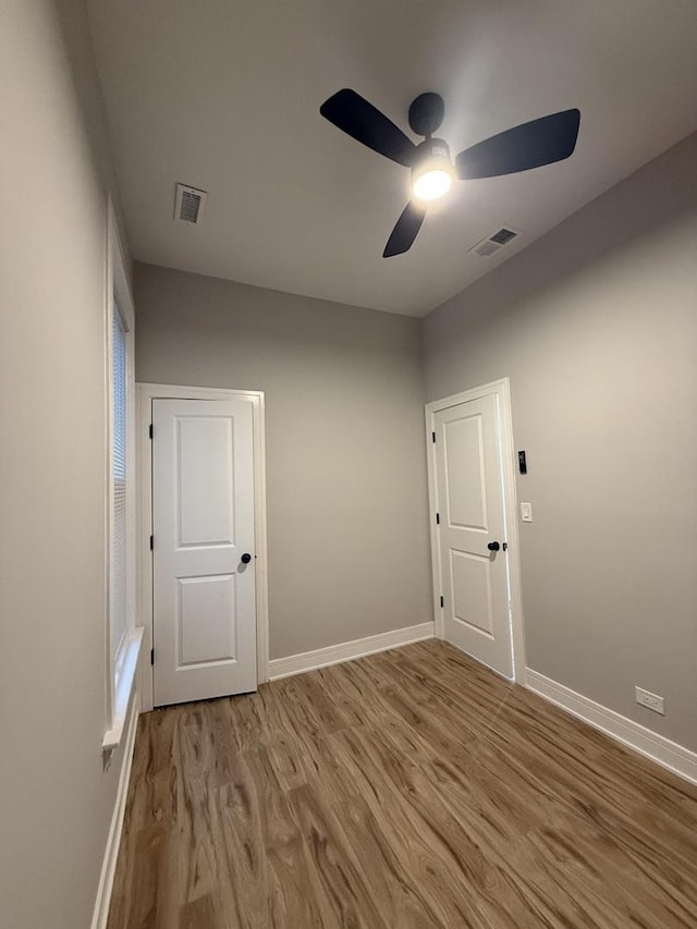 7130 S Morgan St, Chicago, IL 60621 - empty room with wood finished floors and a ceiling fan