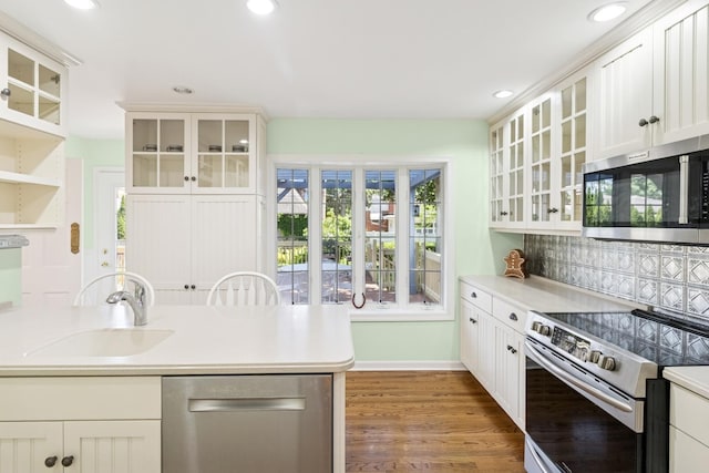 3921 Franklin Ave, Western Springs, IL 60558 - kitchen featuring appliances with stainless steel finishes, tasteful backsplash, light countertops, recessed lighting, and white cabinetry