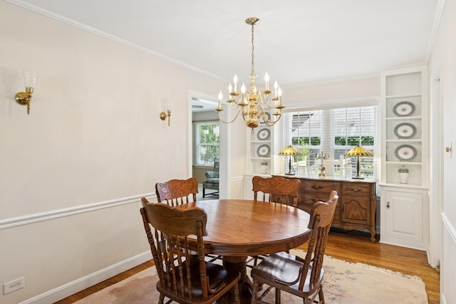 3921 Franklin Ave, Western Springs, IL 60558 - dining room featuring a chandelier, light wood-type flooring, and ornamental molding