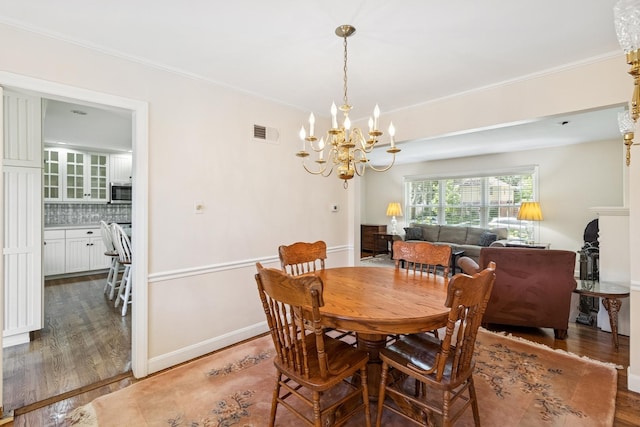 3921 Franklin Ave, Western Springs, IL 60558 - dining room featuring wood finished floors, a chandelier, and crown molding