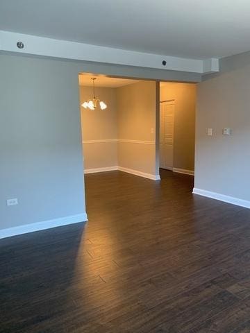 1919 S Wolf Rd Unit 1-322, Hillside, IL 60162 - empty room with a chandelier and dark wood-style floors