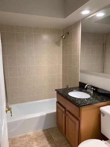 1919 S Wolf Rd Unit 1-322, Hillside, IL 60162 - bathroom with washtub / shower combination, vanity, tile patterned floors, and recessed lighting
