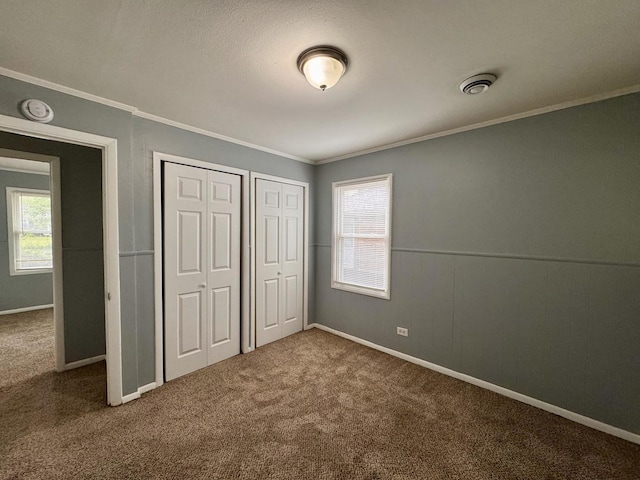 336 Marquette St, Park Forest, IL 60466 - unfurnished bedroom featuring crown molding, multiple windows, carpet floors, and two closets