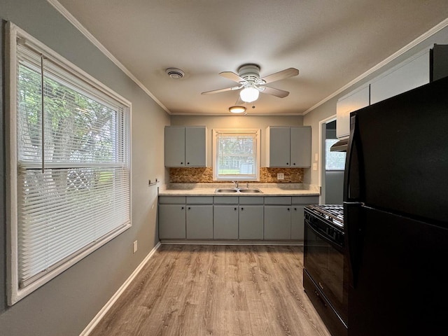 336 Marquette St, Park Forest, IL 60466 - kitchen featuring black appliances, gray cabinets, ornamental molding, backsplash, and light wood-style floors