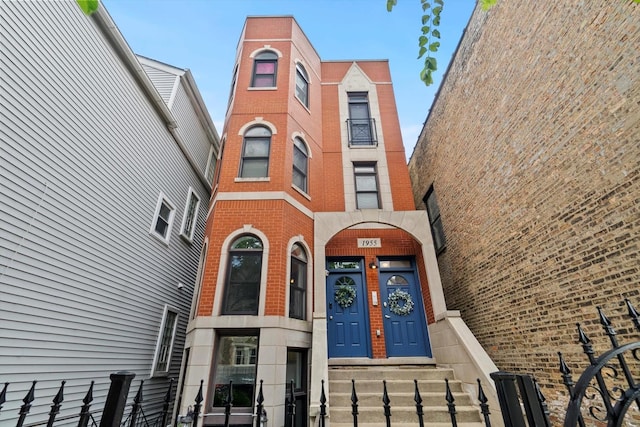 1955 W Melrose St Unit 2, Chicago, IL 60657 - view of front of property with brick siding and a fenced front yard