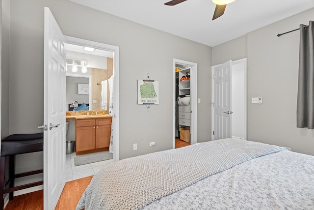 1955 W Melrose St Unit 2, Chicago, IL 60657 - bedroom featuring a spacious closet, a closet, light wood-style flooring, ceiling fan, and ensuite bath