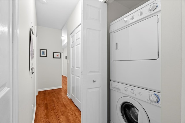 1955 W Melrose St Unit 2, Chicago, IL 60657 - washroom featuring stacked washer and clothes dryer and wood finished floors