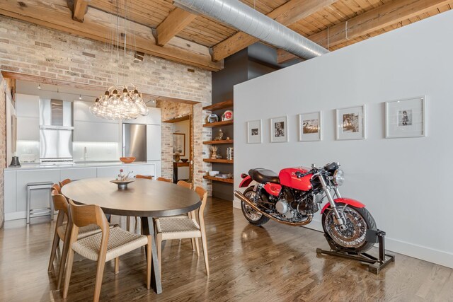 1017 W Washington Blvd Unit 2H, Chicago, IL 60607 - dining room featuring a wood ceiling with exposed beams, a towering ceiling, wood finished floors, brick wall, and a chandelier