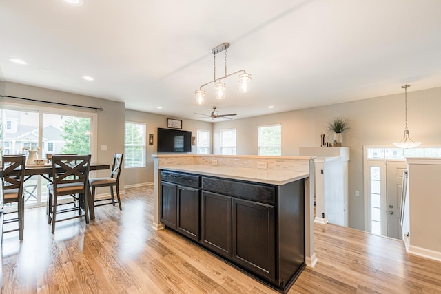 1113 Sapphire Ln, Pingree Grove, IL 60140 - kitchen featuring a ceiling fan, light wood-type flooring, hanging light fixtures, light countertops, and recessed lighting