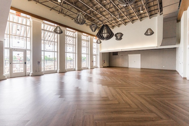 1113 Sapphire Ln, Pingree Grove, IL 60140 - unfurnished living room with a towering ceiling and decorative columns