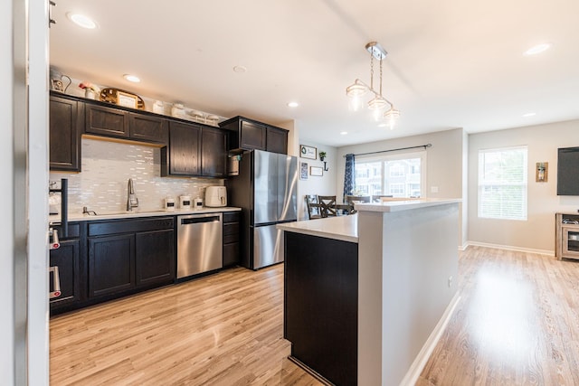 1113 Sapphire Ln, Pingree Grove, IL 60140 - kitchen with appliances with stainless steel finishes, light wood-style floors, light countertops, tasteful backsplash, and recessed lighting