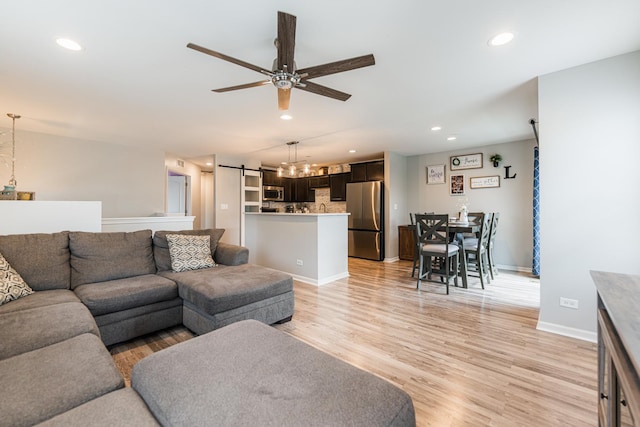 1113 Sapphire Ln, Pingree Grove, IL 60140 - living area featuring a barn door, ceiling fan, recessed lighting, and light wood-type flooring