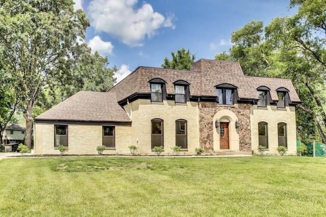 151 S Whitehall Ct, Palatine, IL 60067 - french country home featuring roof with shingles, a front yard, and brick siding