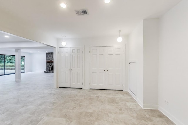 151 S Whitehall Ct, Palatine, IL 60067 - unfurnished room with a brick fireplace and recessed lighting
