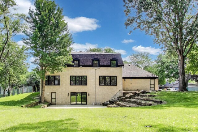 151 S Whitehall Ct, Palatine, IL 60067 - back of property featuring a yard, a patio area, roof with shingles, and brick siding