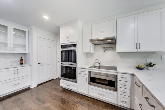 151 S Whitehall Ct, Palatine, IL 60067 - kitchen with stainless steel double oven, black electric cooktop, decorative backsplash, white cabinets, and glass insert cabinets