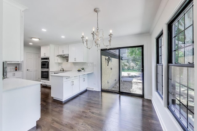 151 S Whitehall Ct, Palatine, IL 60067 - kitchen with double oven, a chandelier, a peninsula, light countertops, and white cabinets