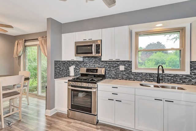 17242 Odell Ave, Tinley Park, IL 60477 - kitchen featuring stainless steel appliances, a ceiling fan, white cabinets, backsplash, and light countertops