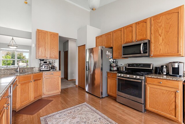 1611 Wintercrest Ln, Shorewood, IL 60404 - kitchen with appliances with stainless steel finishes, a high ceiling, light wood-type flooring, and light stone countertops