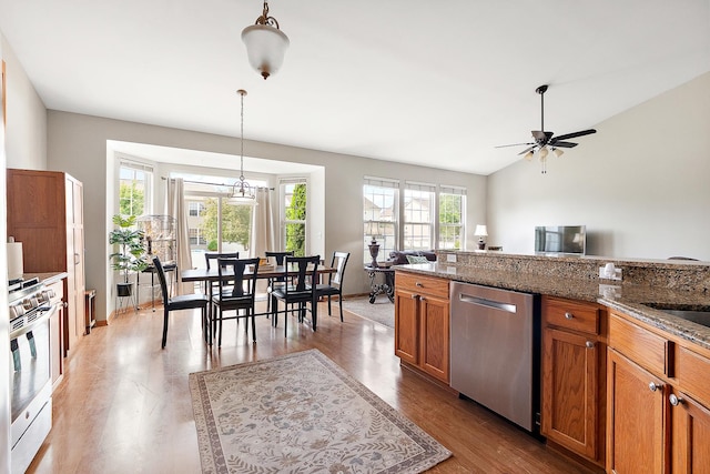 1611 Wintercrest Ln, Shorewood, IL 60404 - kitchen featuring stainless steel appliances, brown cabinetry, ceiling fan, wood finished floors, and vaulted ceiling