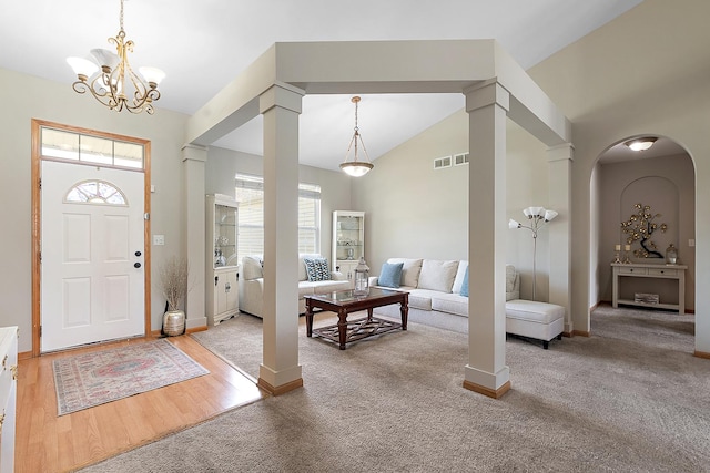 1611 Wintercrest Ln, Shorewood, IL 60404 - carpeted entryway with a chandelier, arched walkways, lofted ceiling, and wood finished floors