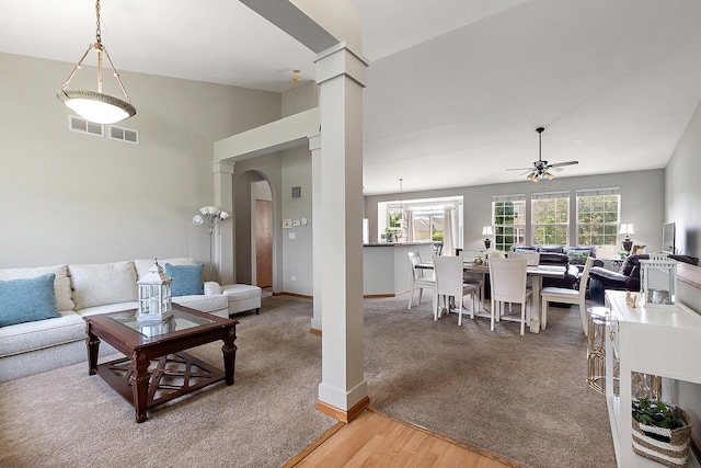 1611 Wintercrest Ln, Shorewood, IL 60404 - living area featuring a ceiling fan, arched walkways, light wood-style flooring, decorative columns, and light carpet