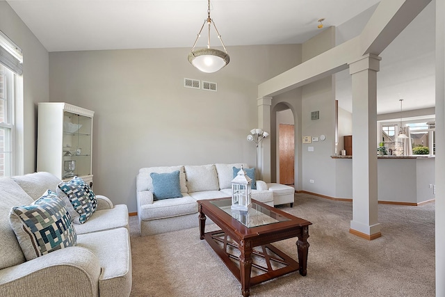 1611 Wintercrest Ln, Shorewood, IL 60404 - carpeted living room featuring arched walkways, decorative columns, and high vaulted ceiling